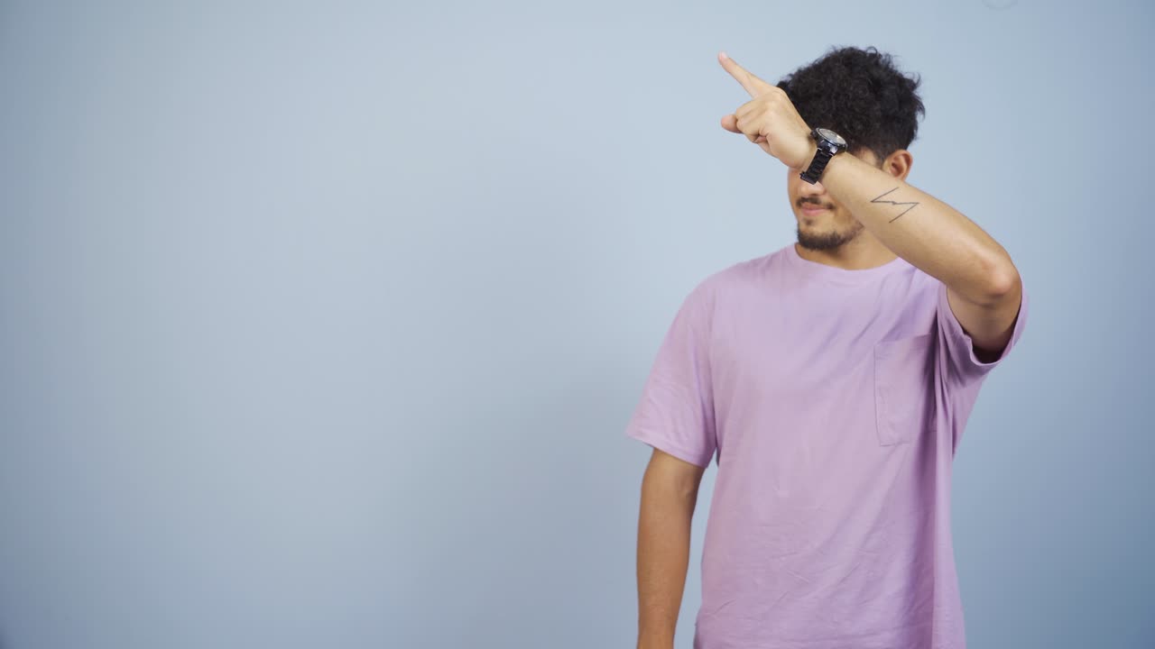 The man promoting is pointing to the side and laughing.