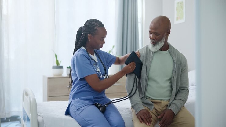 Nurse Taking Blood Pressure of Senior Patient