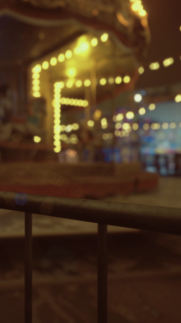 Bright lights shimmer at the fun fair after sunset
