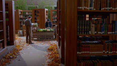 men selling vegetables in a library with autumn leaves on the floor