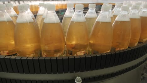 conveyor belt with bottles for juice or water at a modern beverage plant. modern production of sweet soda water