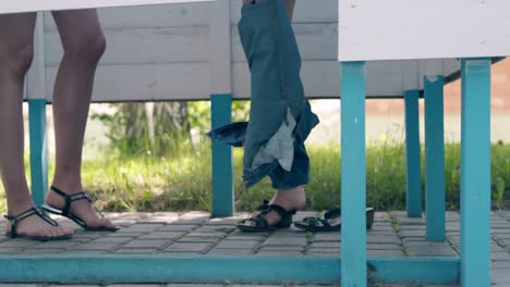 girls dress up in swimsuits stand in booths on beach