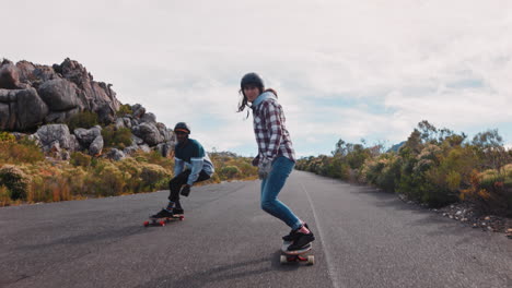 happy multi ethnic friends longboarding together riding fast on beautiful countryside road enjoying relaxed summer vacation cruising using skateboard slow motion close up