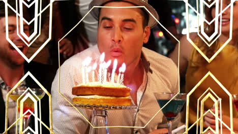 animación de patrón de oro sobre un hombre feliz con un grupo de amigos soplando velas en una fiesta de cumpleaños