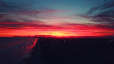 Impresive-aerila-4k-shot-of-beach-of-Itanhaem-in-late-evening-with-crazy-color-sky-and-ocean-in-background,-Brazil