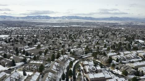 drone flies over snowy neighborhood