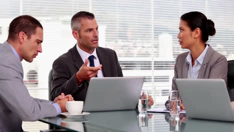 angry businessman pointing at employees