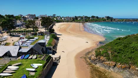 plage de saint-lunaire beach, turquoise waters, coastal town and cliffs, brittany, france. aerial drone descending