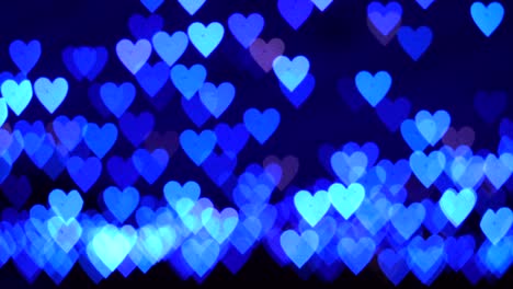 4k uhd video de fondo para el día de san valentín. frontera con bokeh de corazones azules brillantes románticos en un fondo oscuro. amor, bokeh en forma de corazón