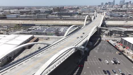 Tracking-cars-on-famous-6th-street-viaduct-bridge-near-downtown-Los-Angeles,-aerial-cityscape