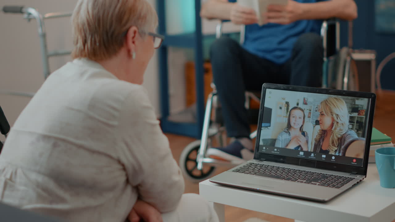 Elderly Woman Video Calling Family on Laptop