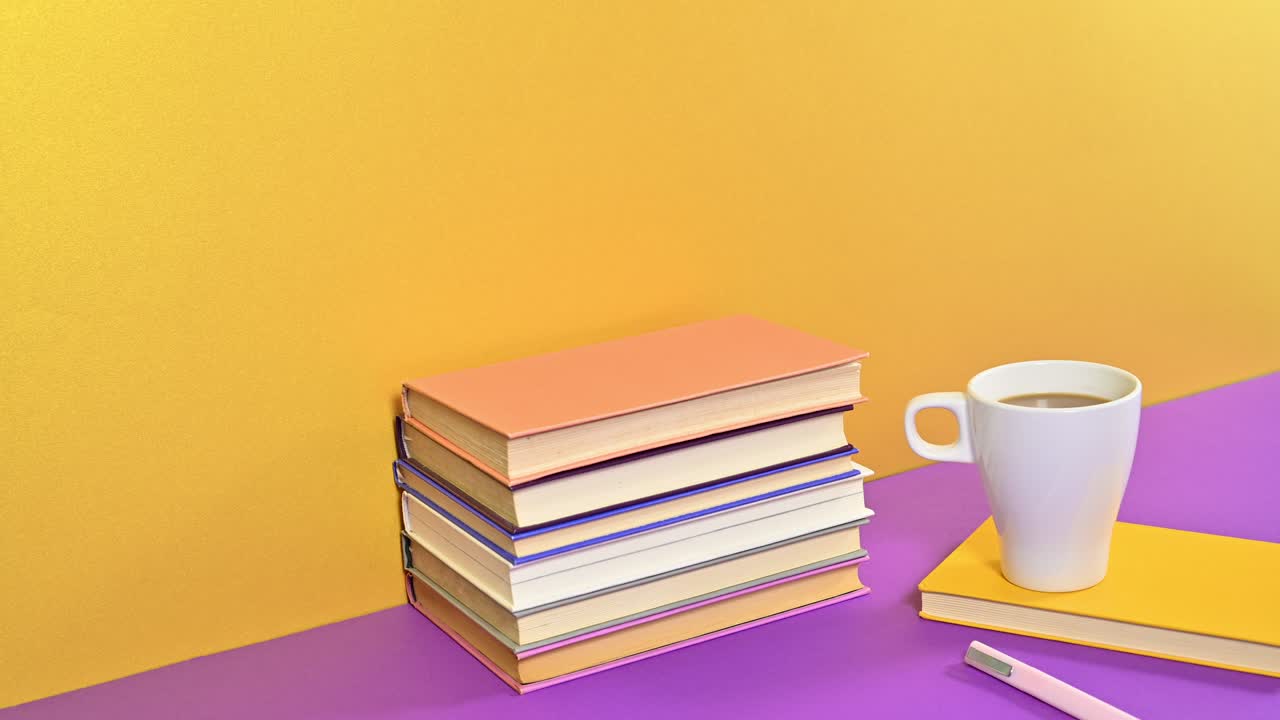 Stack of hardcover vintage books and cup of coffee with pencil appear on purple golden theme. Stop motion animation