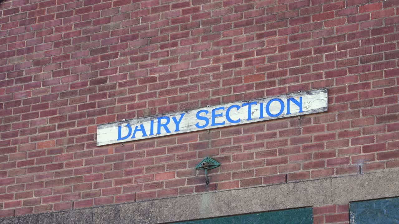 Dairy Section sign on old brick building at British countryside farmers market