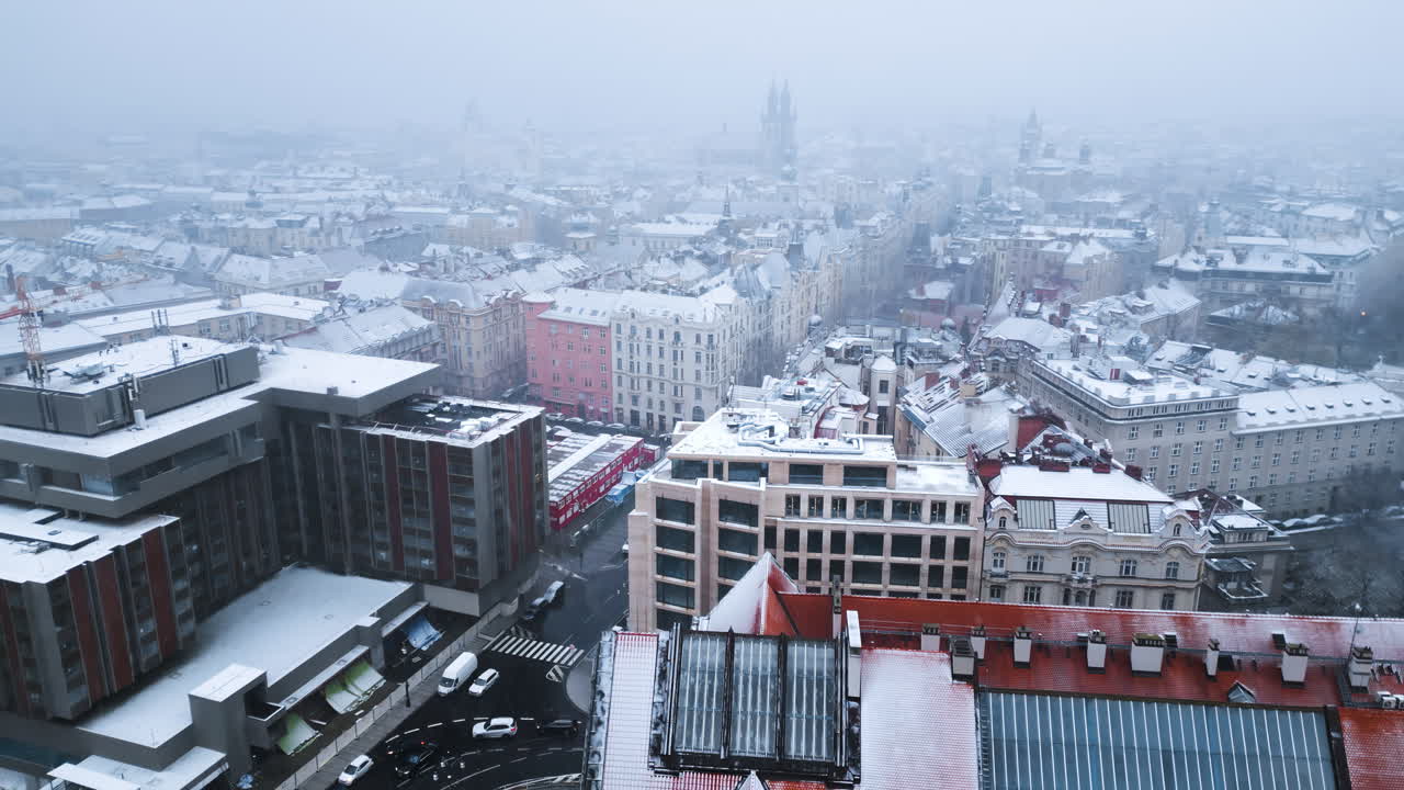 Aerial drone view of Prague city covered in snow with the Old Town square in background. Winter in Czech Republic