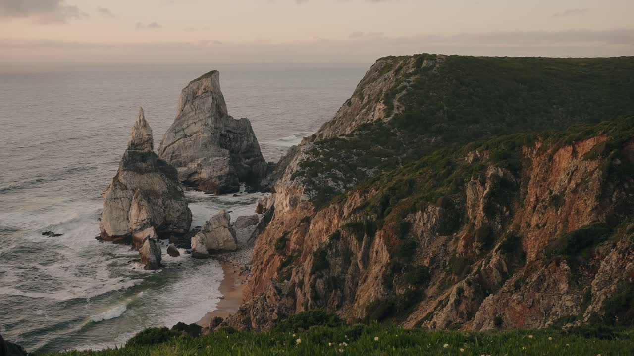 dramatic rocky coastline and sea stacks at Ursa Beach in Sintra Portugal