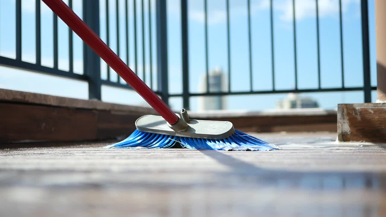 Broom sweeping a balcony