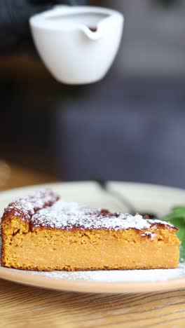 pouring chocolate sauce over pumpkin cake