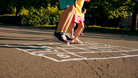 children playing hopscotch outdoors