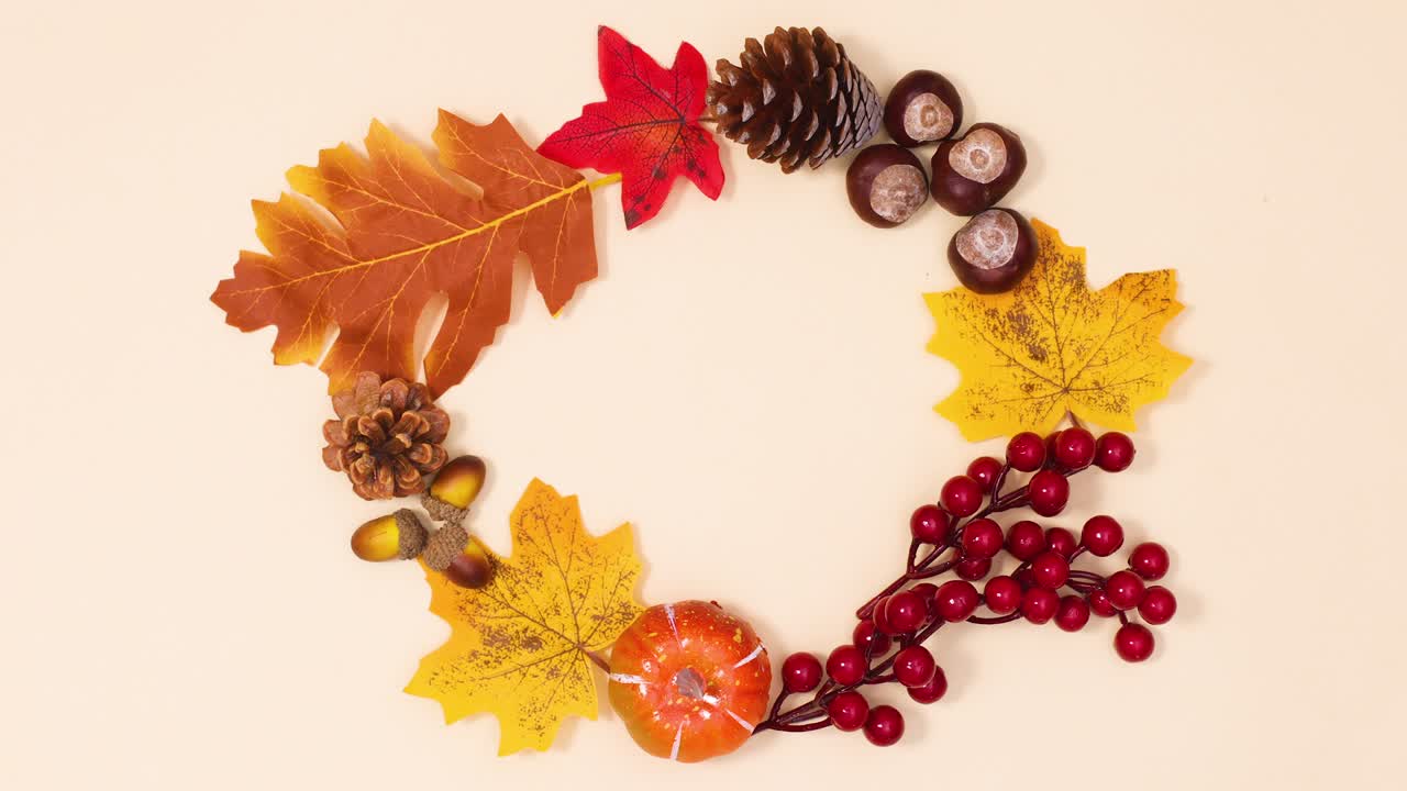 Autumn leaves and frits make round frame for text. Stop motion