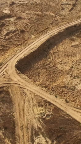 aerial view of a dirt road crossing in a sandy area