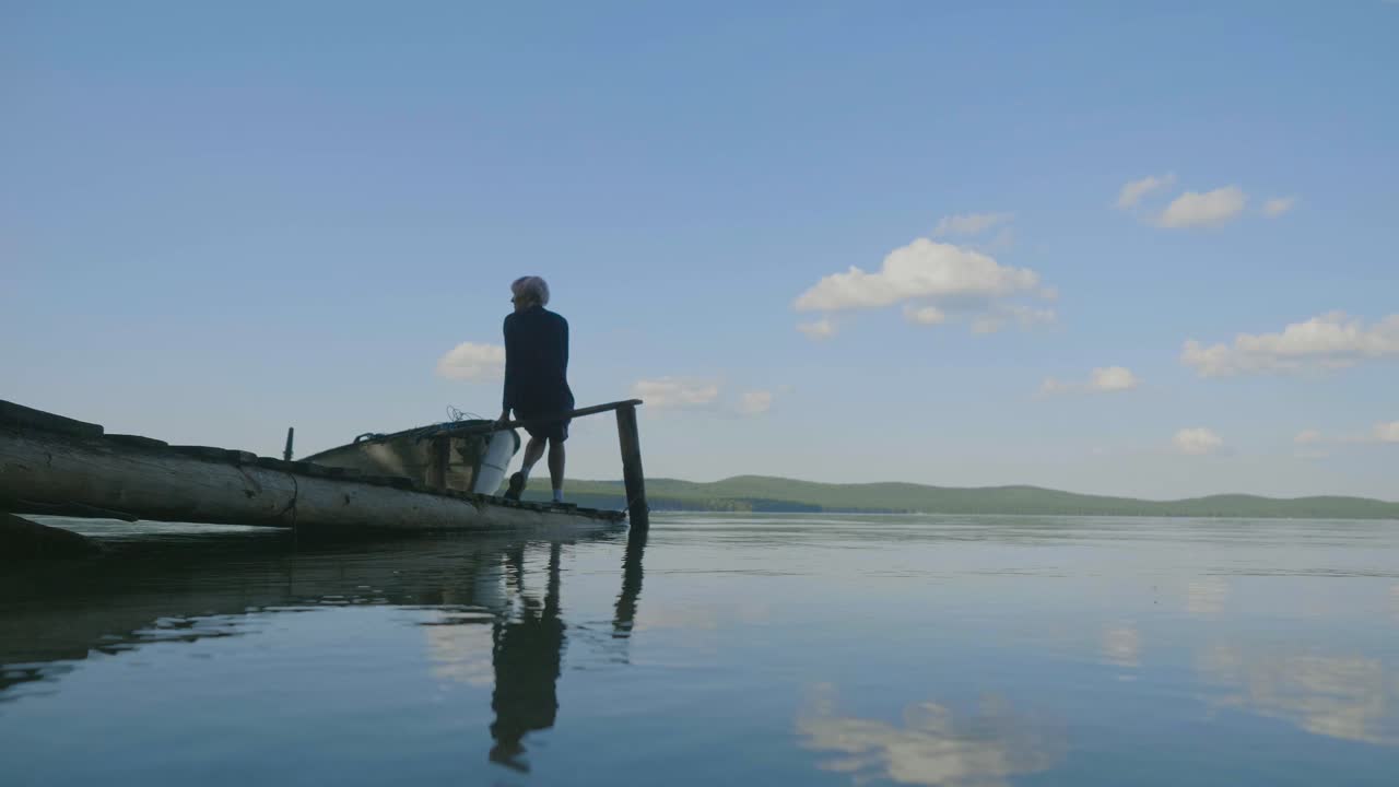 Person on a Wooden Dock by a Lake