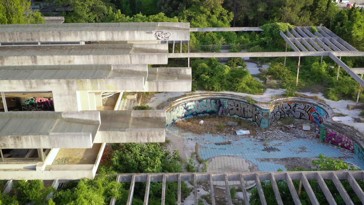 Aerial view of an abandoned pool in the Haludovo Hotel surrounded by vegetation, Croatia
