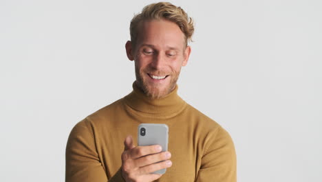 Happy-man-in-sweater-using-phone