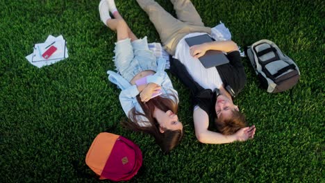 students relaxing on the grass