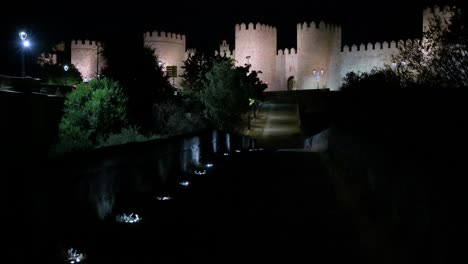 nighttime view of avila, showcasing the illuminated medieval walls and the historic old town, a unesco world heritage site.