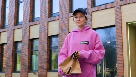 Young-woman-holding-paper-bags-on-the-street