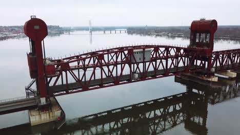 aerial shot of a railroad drawbridge lifting or raising over the mississippi river near burlington iowa