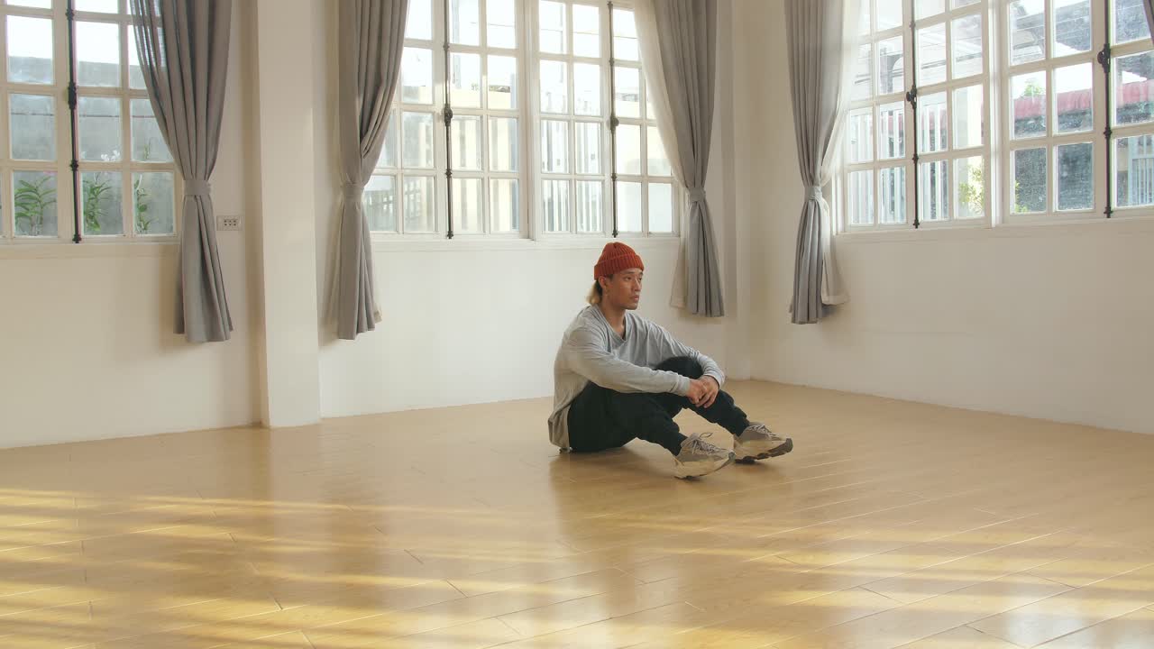 Asian Male Dancer Sitting On Floor And Rest, Video In 4K 50Fps