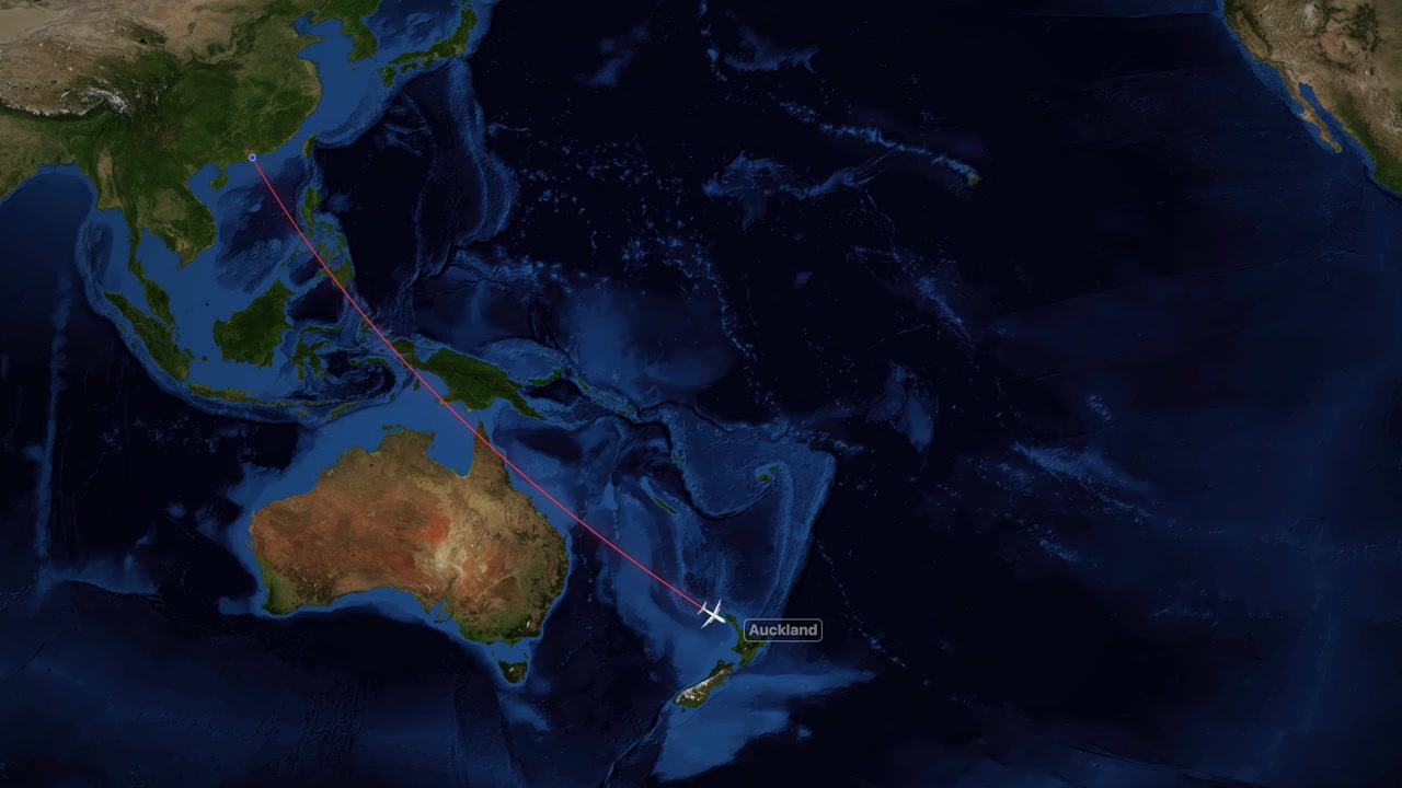 A digital world map tracks a plane flying from Hong Kong to Auckland, New Zealand