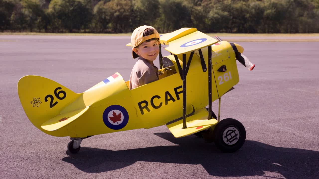 Boy in a Yellow Toy Airplane