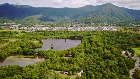 Aerial-footage-of-Cattana-Wetlands,-urban-area-of-Smithfield,-and-forested-mountains-near-Cairns,-Queensland,-Australia