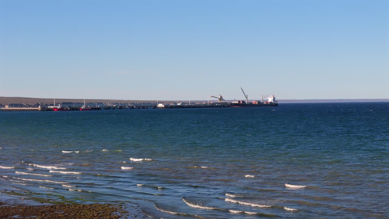 Aerial shot of a small ship harbour on the coast of Puerto Madryn. There are small fishing boats there