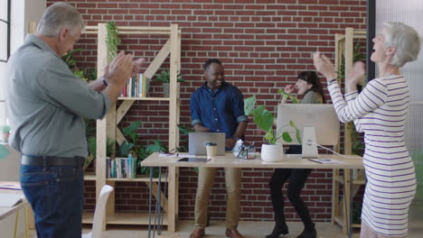 diverse business people dancing excited celebrating successful company start up happy coworkers cheering arms raised in modern office workspace