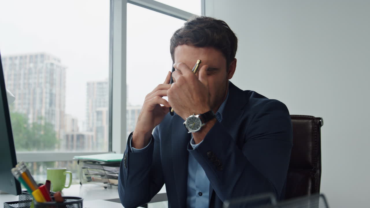 Stressed manager talking cellphone dealing business problems. Client hold papers