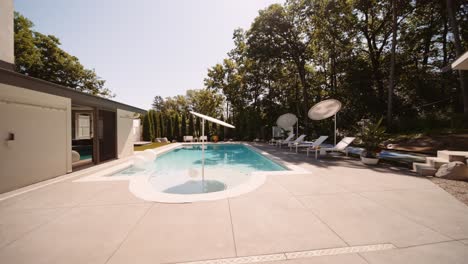 rotating push in shot of a pool area in the backyard of a luxury home