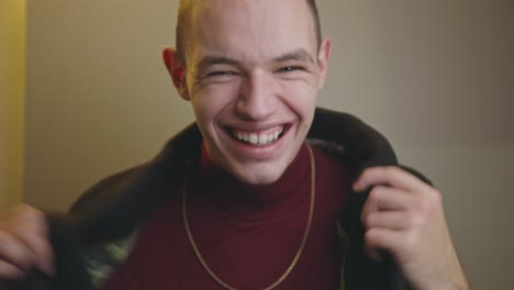 portrait of happy young man with a great smile isolated on off-white wall background - medium closeup shot