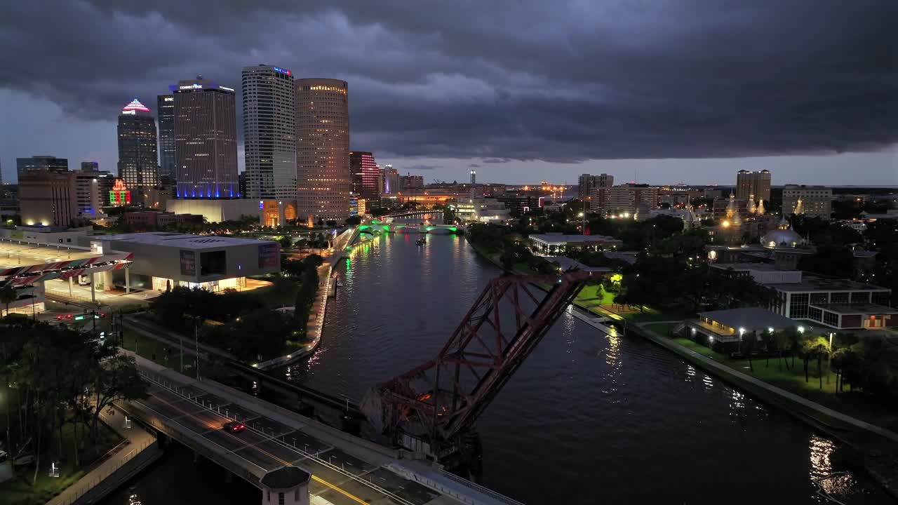 Aerial Night View of a City Skyline with an Illuminated Drawbridge over a River