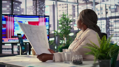 businesswoman reviewing blueprints in a modern office