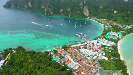 Aerial-panoramic-overview-of-koh-phi-phi-harbor,-boats-exiting-for-day's-adventure