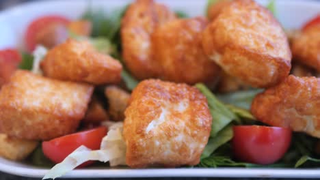 fried cheese salad with tomatoes and croutons