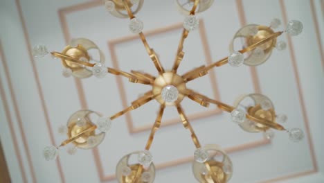 a ceiling decorated by chandelier, close up shot