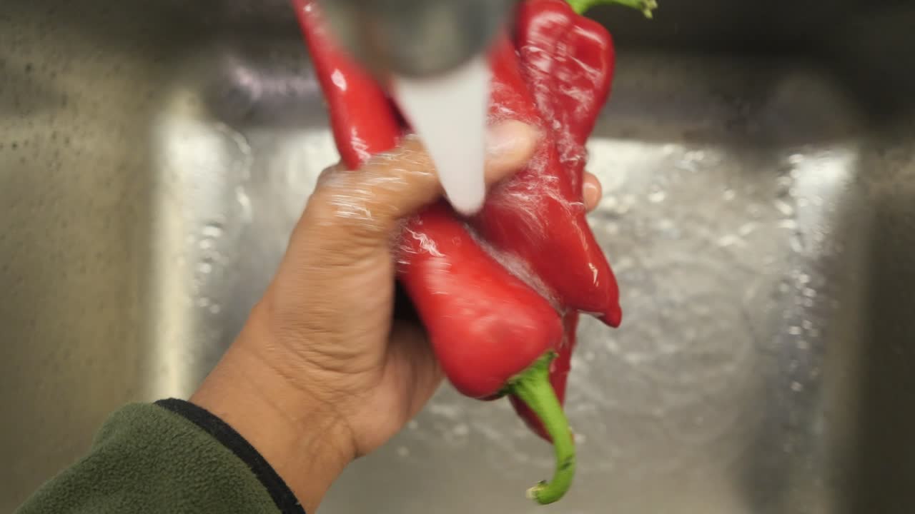Washing Red Peppers Under Running Water
