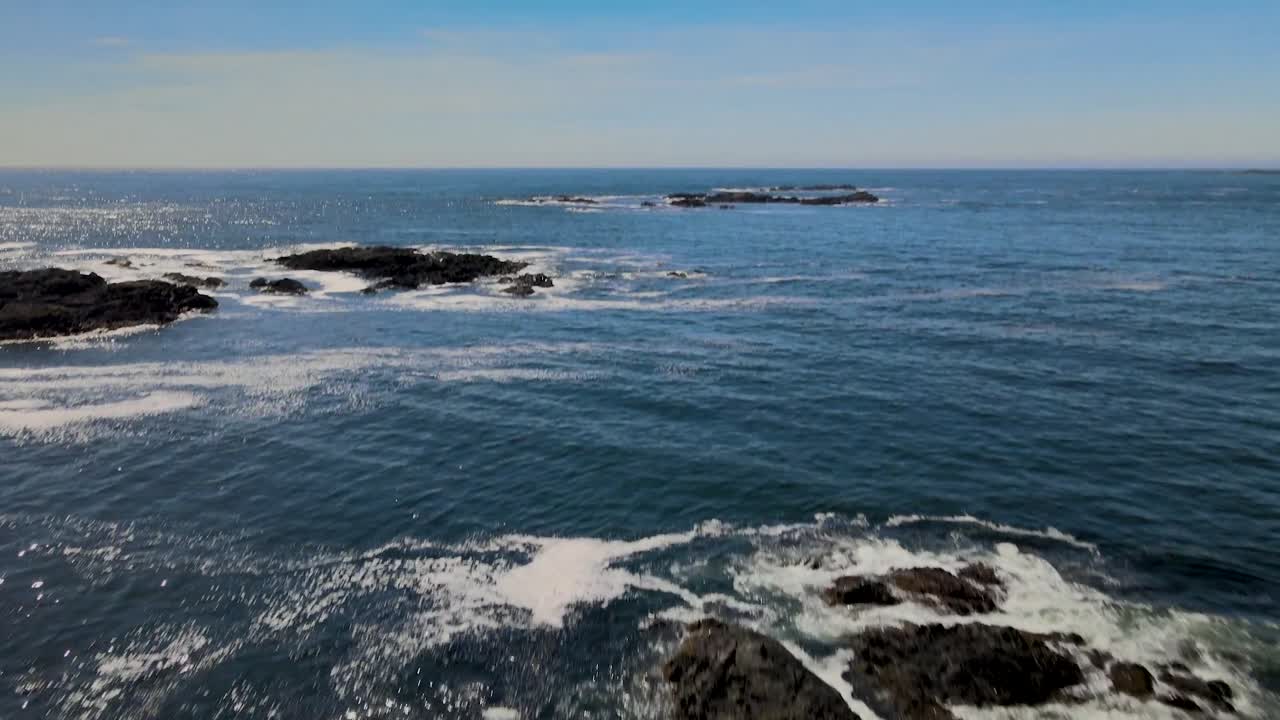 Drone shot of ocean toward mountains