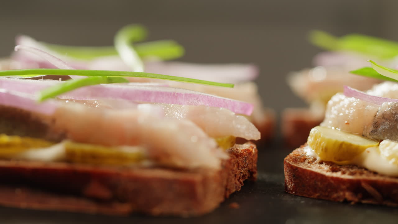 Close-up of Smoked Fish Sandwiches with Pickles and Onions