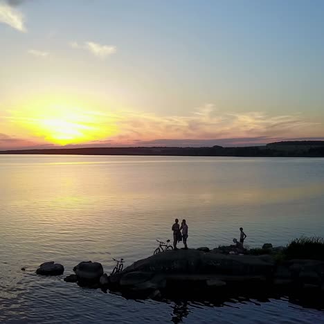 people enjoying the riverside sunset