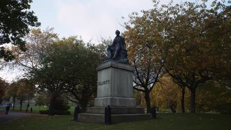 ebenezer elliott statue at western park during autumn season, university of sheffield campus, sheffield, south yorkshire, uk.